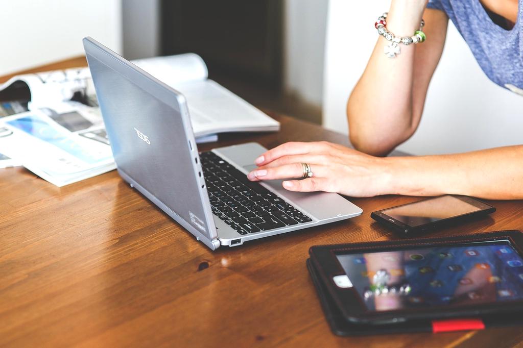 Hands typing on smartphone with social media apps